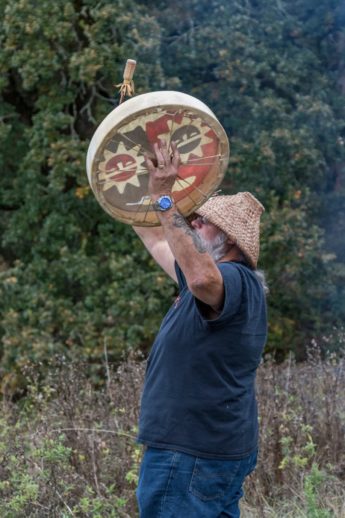 Chinook Tribal Vice Chairman, Sam Robinson playing a drum during the blessing of food and friendship before the traditional salmon bake at the Cathlapotle Plankhouse, Sun., Oct. 2 at the Carty Unit of the Ridgefield National Wildlife Refuge during Bird Fest. Photo by Mike Schultz.