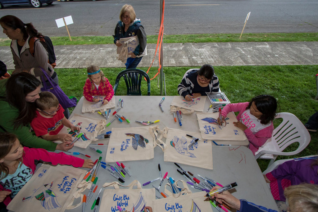 Children coloring tote bags at Davis park in downtown Ridgefield during the Bird Fest. Photo by Mike Schultz.