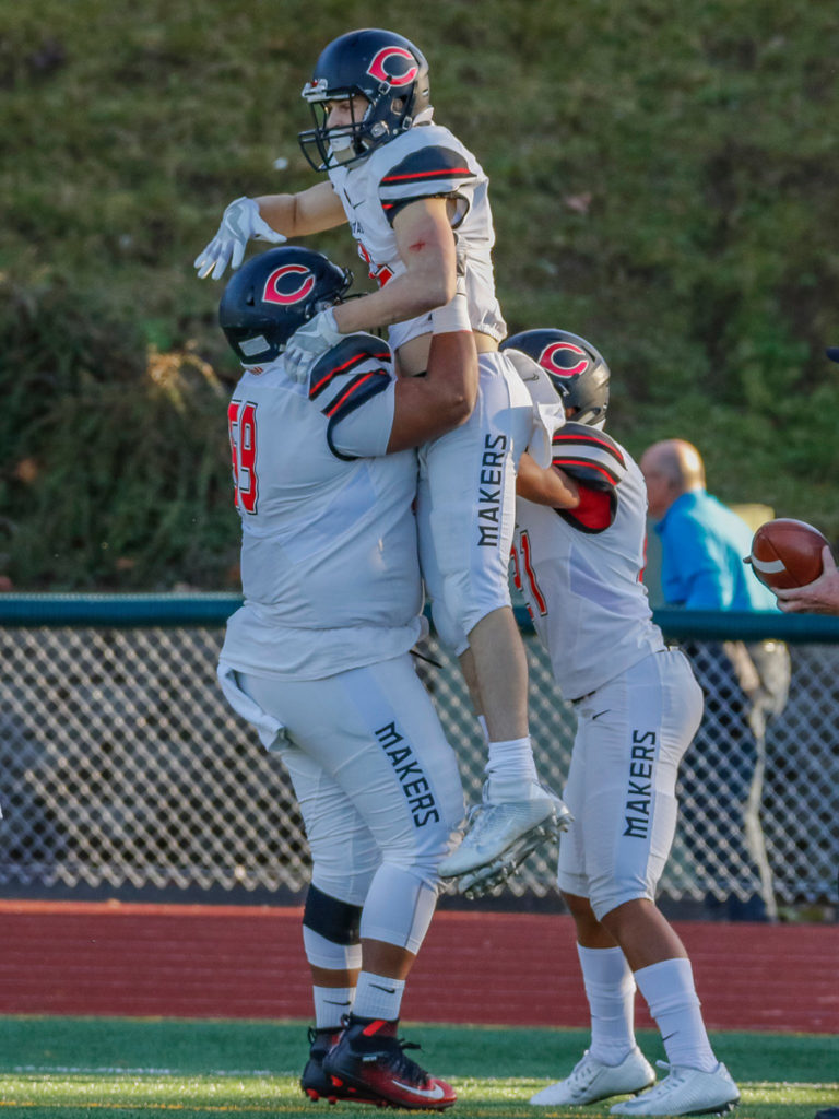 Camas offensive lineman Marcus Gray (59) celebrates a touchdown by wide receiver Ryan Rushall (2)