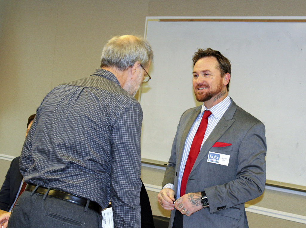 Eric Holt (right), a progressive candidate running for a state senate seat in Legislative District 18, greets Neighborhood Associations Council of Clark County Chairman Paul Ballou at the NACCC’s bipartisan candidates forum held Wed., Oct. 12 in Camas. Photo by Kelly Moyer
