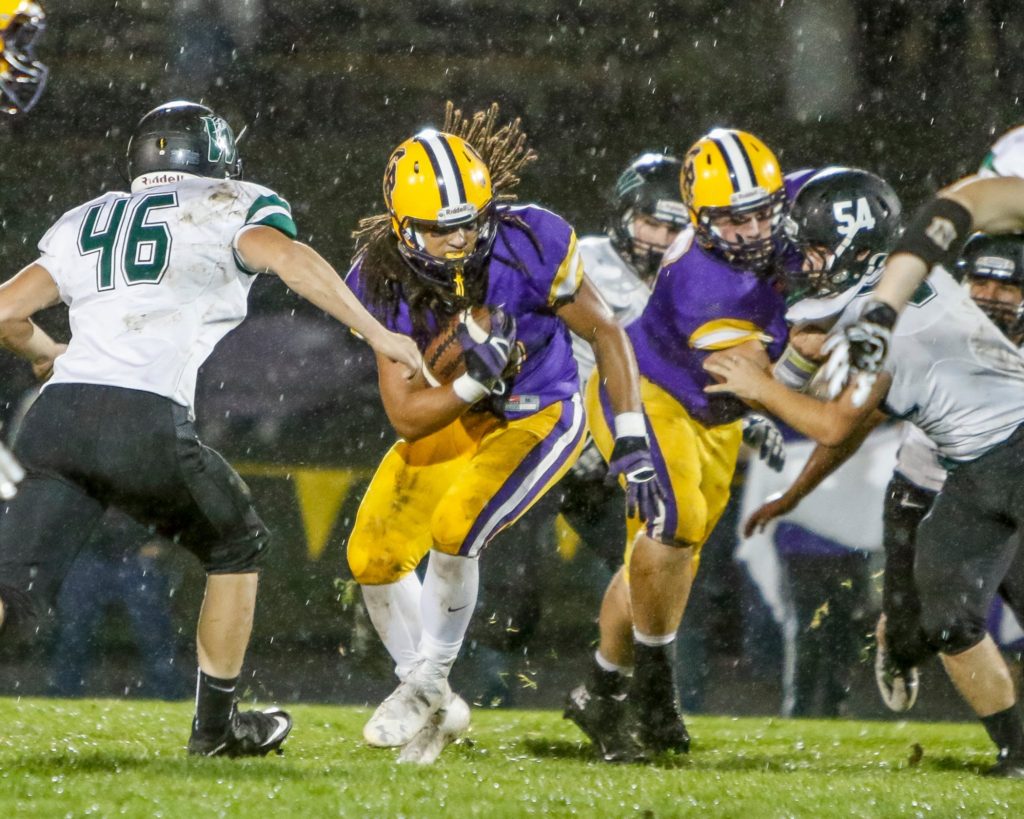 Columbia River running back Hunter Pearson (30) looks for yardage against Woodland Friday. Photo by Mike Schultz.