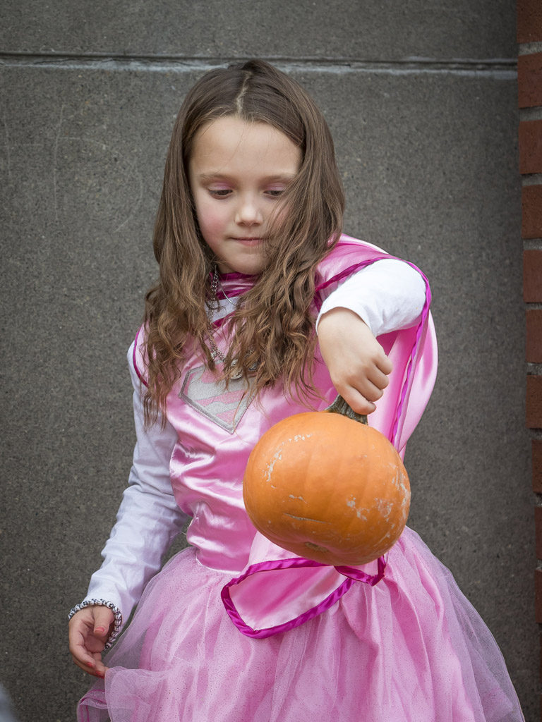 Makaylie Vandelden displays the pumpkin she received Wednesday at the Downtown Washougal Pumpkin Harvest Festival. Photo by Mike Schultz