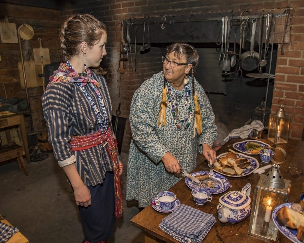 Sydney Jenkins and Sally Rothnacker-Peyton are shown here preparing food in the kitchen Saturday at the annual ‘Christmas at Fort Vancouver’ event at the Fort Vancouver National Historic site. Photo by Mike Schultz