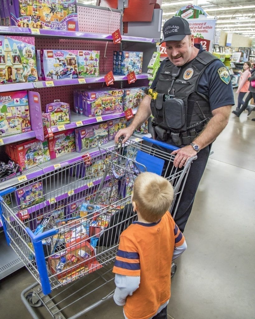 Terry Casey, of the Woodland Police Department, and his youngster still have room to fill in their shopping cart. Photo by Mike Schultz