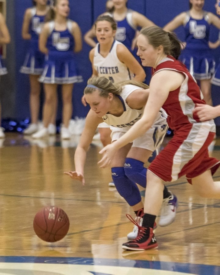 Junior guard Molly Edwards (10) is shown here fighting for possession of the basketball in a recent victory over Castle Rock. Edwards is averaging 12.7 points per game this season. Photo by Mike Schultz