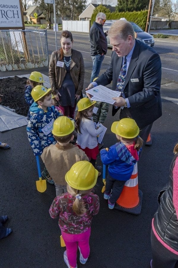 Battle Ground Public Works Director Scott Sawyer hands out certificates to each of the children from Battle Ground’s Country Campus Learning Center who attended the South Parkway Improvement Project groundbreaking ceremony on Thursday morning. Photo by Mike Schultz
