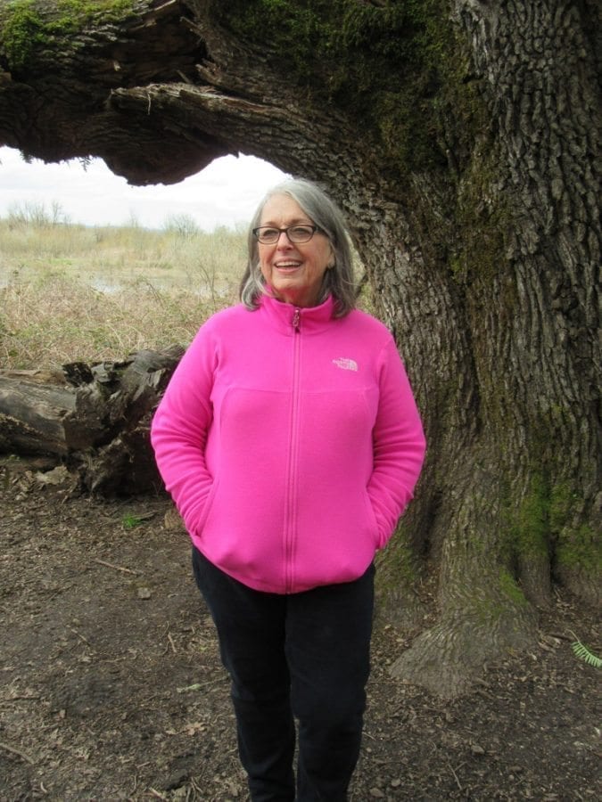 Virginia Scott stands in front of the more-than-400-year-old Mother Tree in the Carty Unit of the Ridgefield National Wildlife Refuge. Photo by Carolyn Schultz-Rathbun