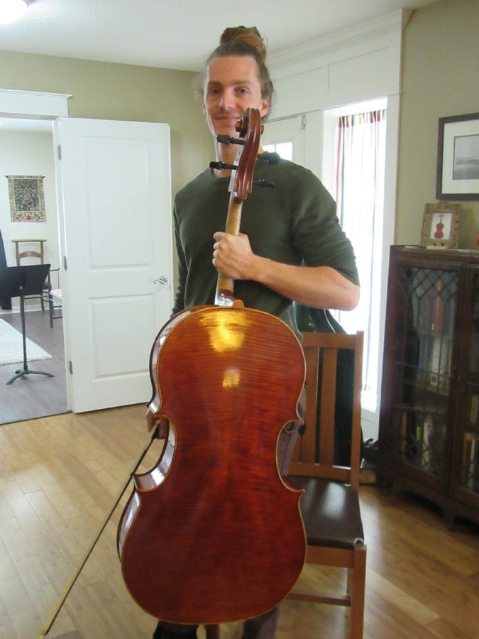Portland cellist Tim Berte-Renou is shown here with Mark Moreland's newest cello. Photo courtesy of Carolyn Schultz-Rathbun