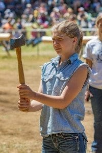 Delaney Brown shows the concentration she used to place first in the 10-13 age division of the axe throw at the Amboy Territorial Days competition Saturday. Photo by Mike Schultz