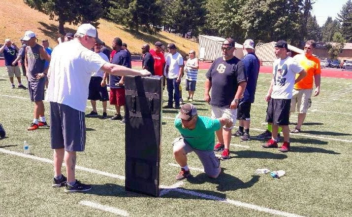 The purpose of the clinic was to “coach the coaches, teach the teachers.” More than 100 Clark County Youth Football coaches went through tackling drills Saturday at McKenzie Stadium. Photo courtesy of CCYF