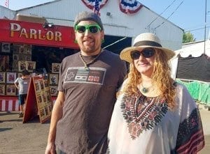 Jeremy Rogers and Stephanie Wood, both of Vancouver, said they love standing in line with so many people for a free breakfast at the opening day of the Clark County Fair. Photo by Paul Valencia