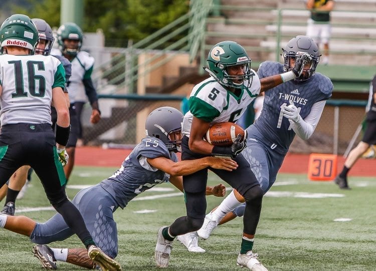 Evergreen needs one win in its final two games to clinch a playoff berth. Here, Jerontae Burns (5) battles for yardage in a game earlier this season against Heritage. Photo by Mike Schultz