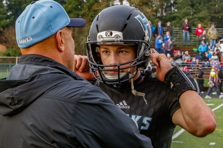 Hockinson quarterback Canon Racanelli, shown here taking instructions from Coach Rick Steele during a recent state playoff game, has an eye-opening 50 touchdown passes this season. Photo by Mike Schultz