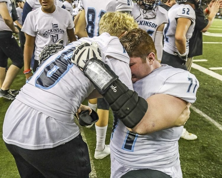 Hockinson linemen Nathan Balderas (71) and Liam Heinl (78) share a hug as the clock winds down in the Hawks’ state championship victory over Tumwater Saturday in the Tacoma Dome. Photo by Mike Schultz