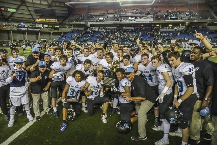 The 2017 Hockinson High School football team poses with the Class 2A state championship trophy Saturday after defeating Tumwater 35-22 in the championship game at the Tacoma Dome. Photo by Mike Schultz