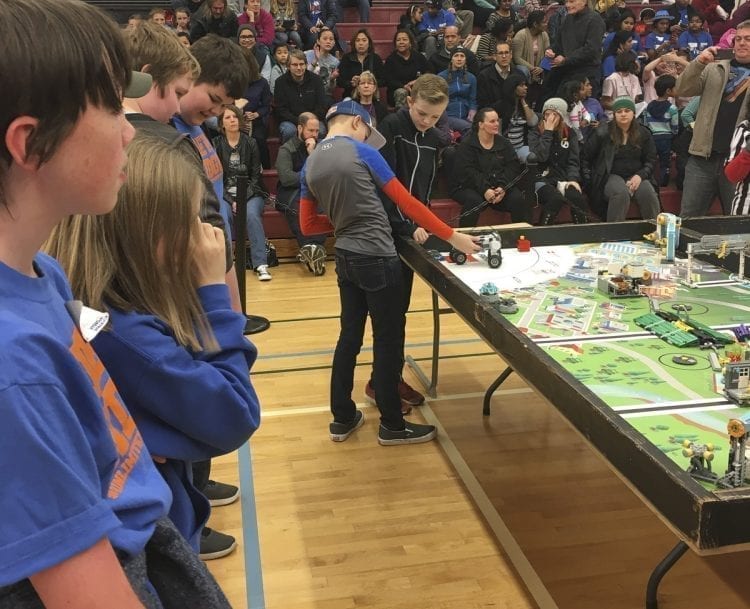 View Ridge Middle School students Cayden Lauder (left) and Kaison Apol prepare their robot at a FIRST LEGO League competition in Olympia in December as their teammates (far left) look on. Photo courtesy of Ridgefield School District