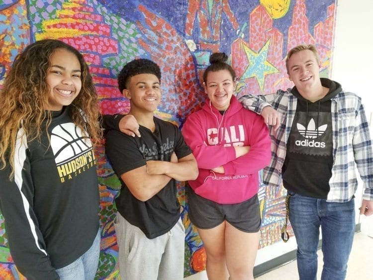 Hudson’s Bay basketball players (left to right) Jaydia Martin, Quadrese Teague, Stacia Mikaele, and Nate Buslach are all smiles Monday. Among the team leaders, they got to recall a special night from this weekend when the girls and boys squads each won a bi-district playoff game, on the same night, in the same gym. Photo by Paul Valencia