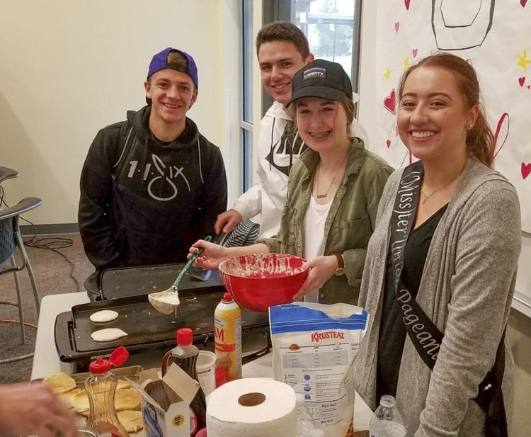Kaitlyn Milliken, right, one of 15 contestants this year for (Miss)ter Union. However, it really is a school-wide event, a large group effort for this charity fundraiser. Senior Gabe Rodgers, left, was a contestant last year. And sophomores Lucas Horowitz and Katie Boda, helped Milliken with her pancake drive Thursday morning. Photo by Paul Valencia