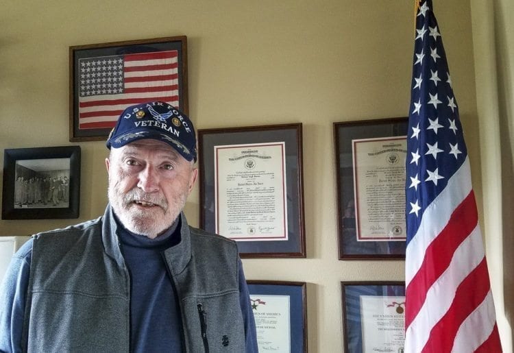 Michael Burton stands in front of many of his memories from his days as an officer in the U.S. Air Force. The Vietnam veteran went nearly 40 years before getting help for posttraumatic stress disorder. Now, it it is his mission in life to help other veterans, reminding them it is never too late. Photo by Paul Valencia
