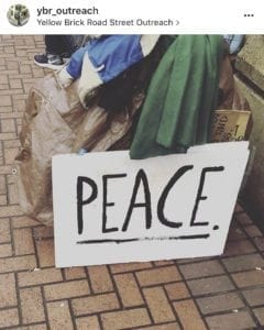 This sign sits against one homeless person’s possessions in downtown Vancouver. Photo courtesy Janus Youth Services