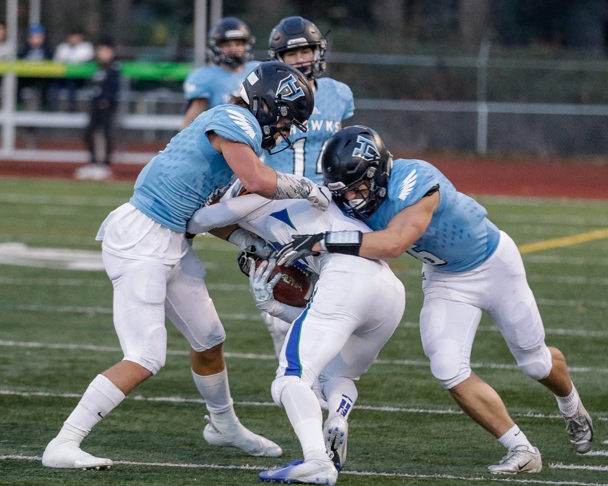 Hockinson defenders Sawyer Racanelli (11) and Nick Frichti (6) stop a Liberty runner during Saturday’s semifinal win at McKenzie Stadium. The Hawks’ defense shutout Liberty in the second half. Photo by Mike Schultz