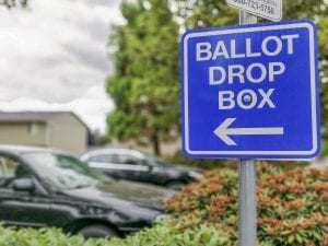 A sign points to a ballot drop off location. File photo by Chris Brown