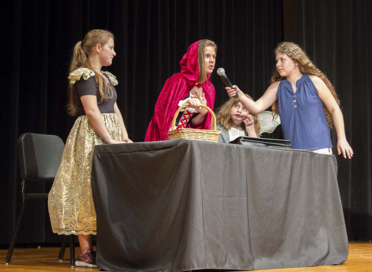 Calista Conder plays a journalist interviewing Little Red Riding Hood, played by Savannah Doughty with Grandmother Hood played by Caitlin Nelson looking on. Photo courtesy of Woodland School District