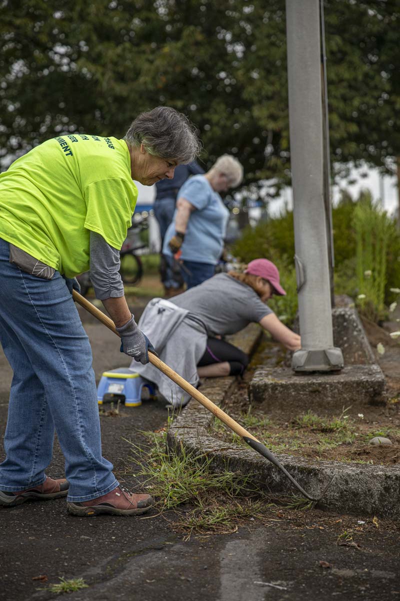 Su Scott (front), Bryn Howell (next back), and Nancy Wilson (last back) clean out garden beds at the Inter-Faith Treasure House in Washougal. Photo by Jacob Granneman