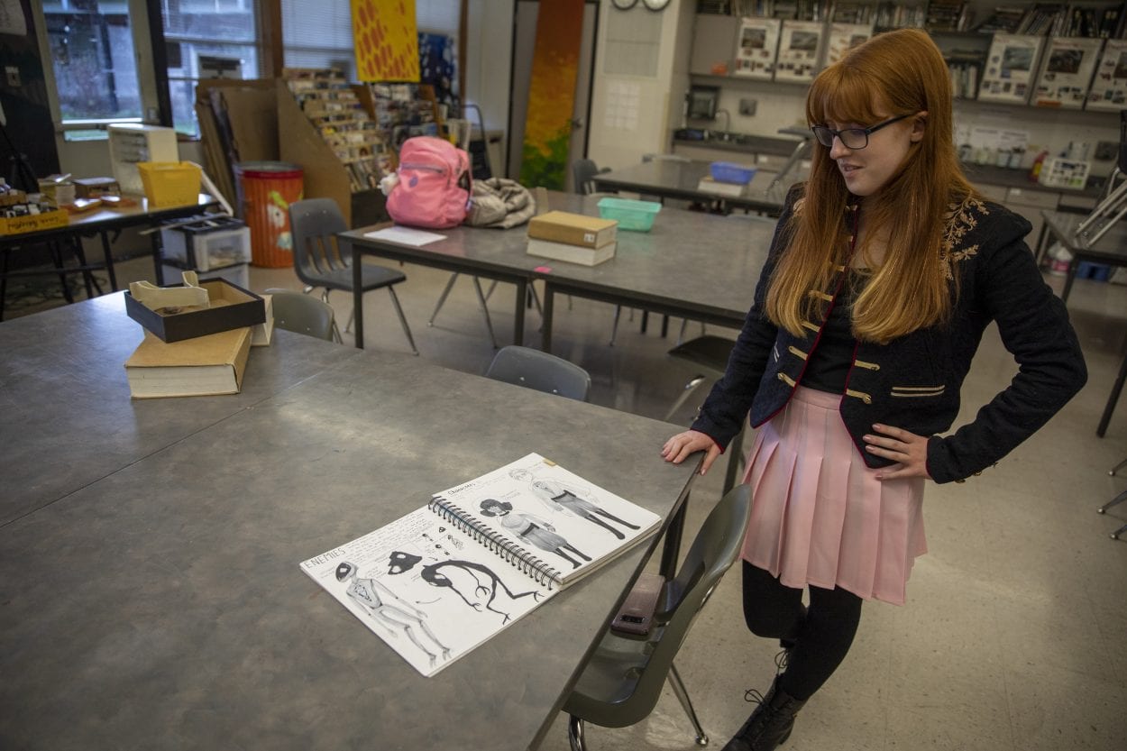 Bridgette Bromell is seen here looking over her original sketches and drawings for her Google Play game, Lune. Photo by Jacob Granneman