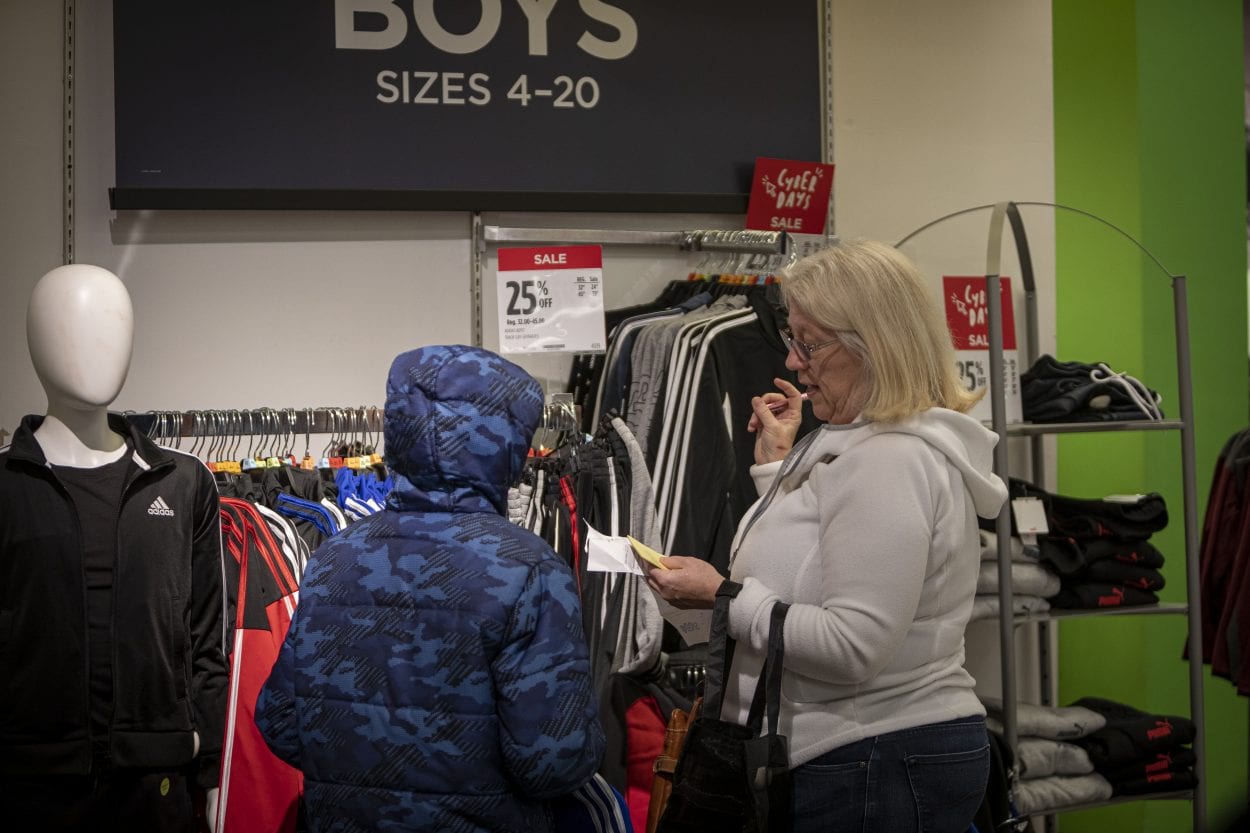 Tracy Pate helps her paired child, Evan find new shirts during the 2019 Santa Clothes event at the Vancouver Mall. Photo by Jacob Granneman