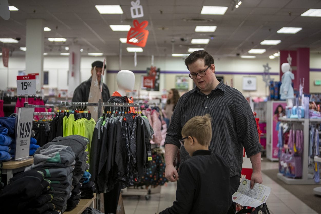  Nathan Campbell helps his new friend Jaxon Melton find new clothes on his list during Santa Clothes at JC Penny. Photo by Jacob Granneman 