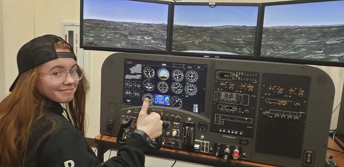 Battle Ground High School junior Brooke Kirby sits at the controls of a flight simulator. Photo courtesy of Battle Ground Public Schools