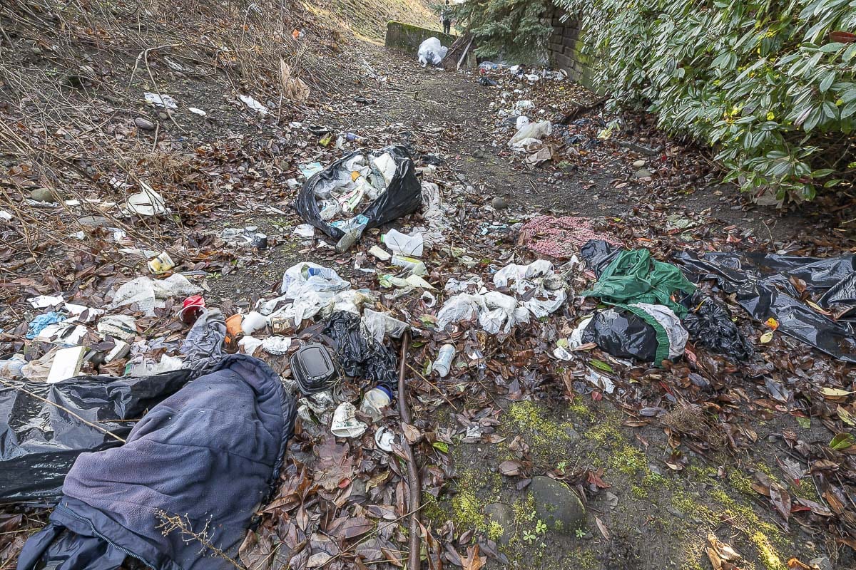 Garbage, including drug paraphernalia, is left behind at a homeless encampment along Columbia Way in Vancouver. Photo by Mike Schultz