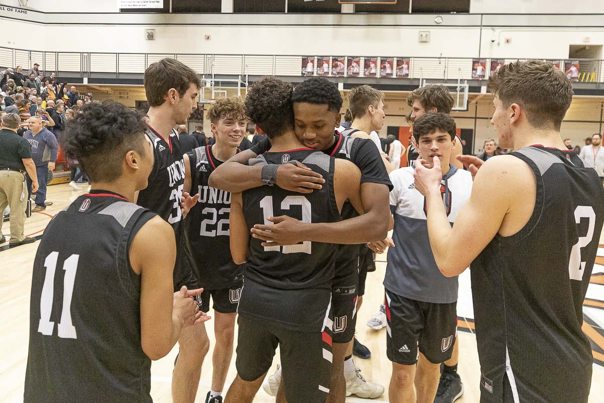 Ariya Briscoe (12) gets hugs and congratulations from his teammates Tuesday night after his basket with two seconds to play gave Union a 73-72 win over Battle Ground. Photo by Mike Schultz