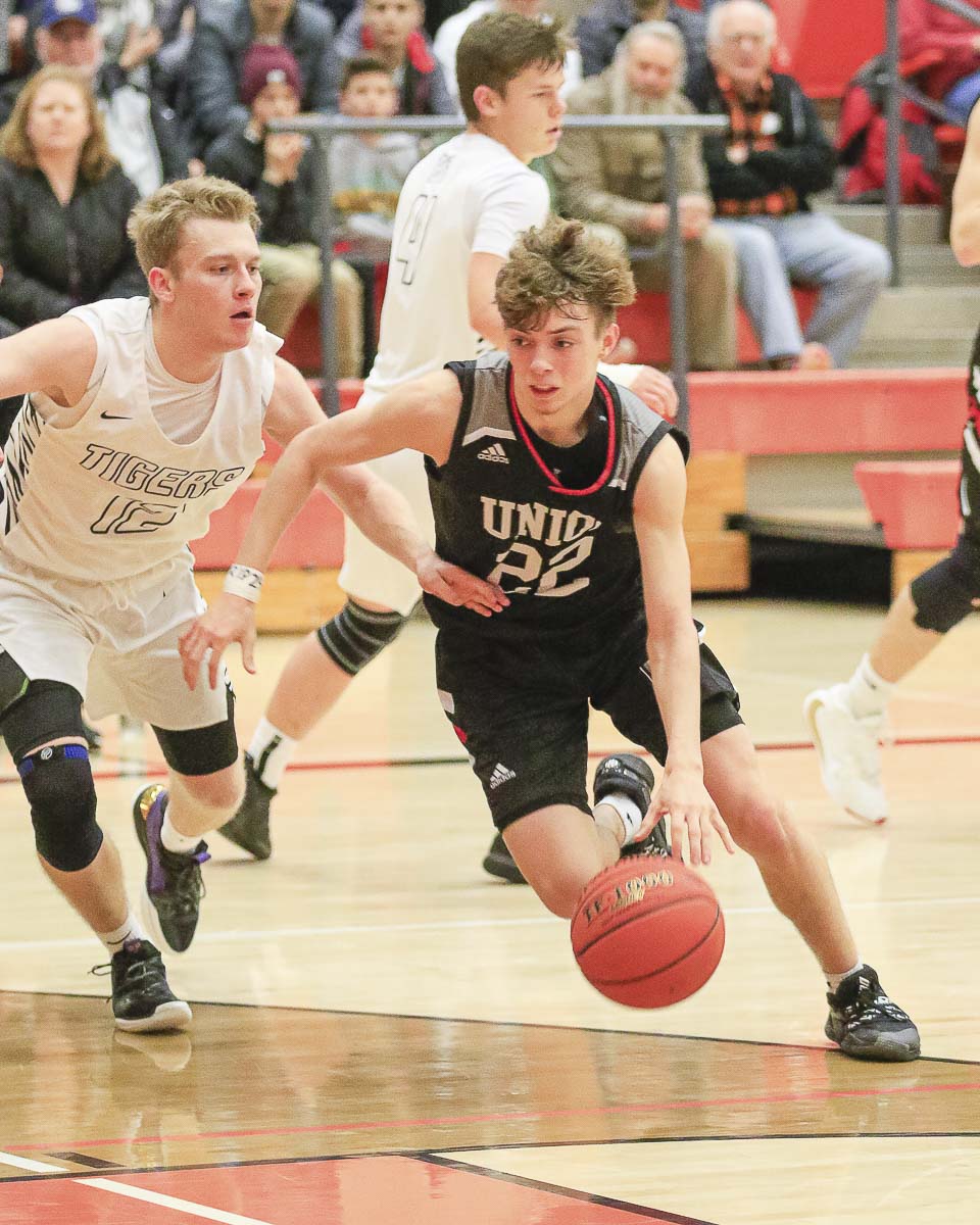 Union’s Kaden Horn tries to get past the defense of Battle Ground’s Brendan Beall on Tuesday. Horn came off the bench and gave Union quite the lift in his team’s comeback victory. Photo by Mike Schultz