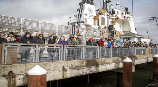 Students from Wy’east Middle School in Vancouver line the dock in Astoria, Ore. waiting for the launch of their mini-boat, “Liberty.” Photo by Jacob Granneman