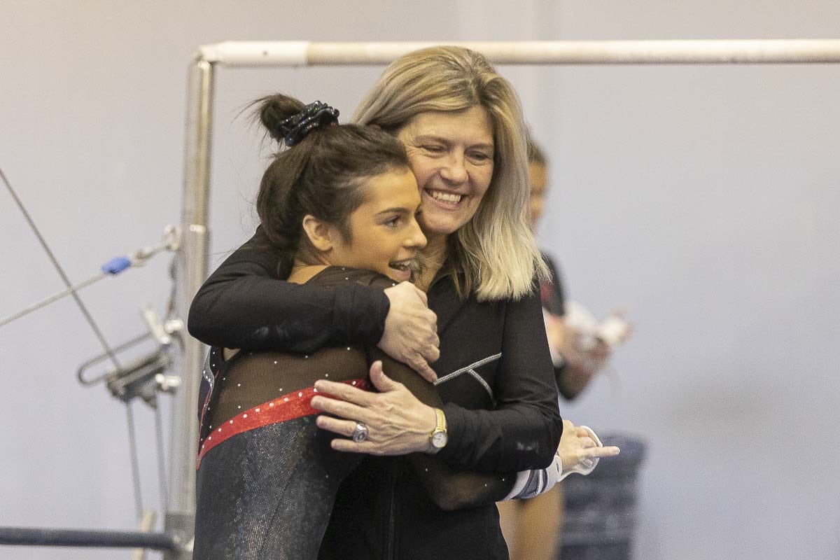 Camas coach Carol Willson gives Annika Affleck a hug after a recent gymnastics meet. Willson said the key is that she and her assistants show love to the athletes first. The sport comes second. Photo by Mike Schultz