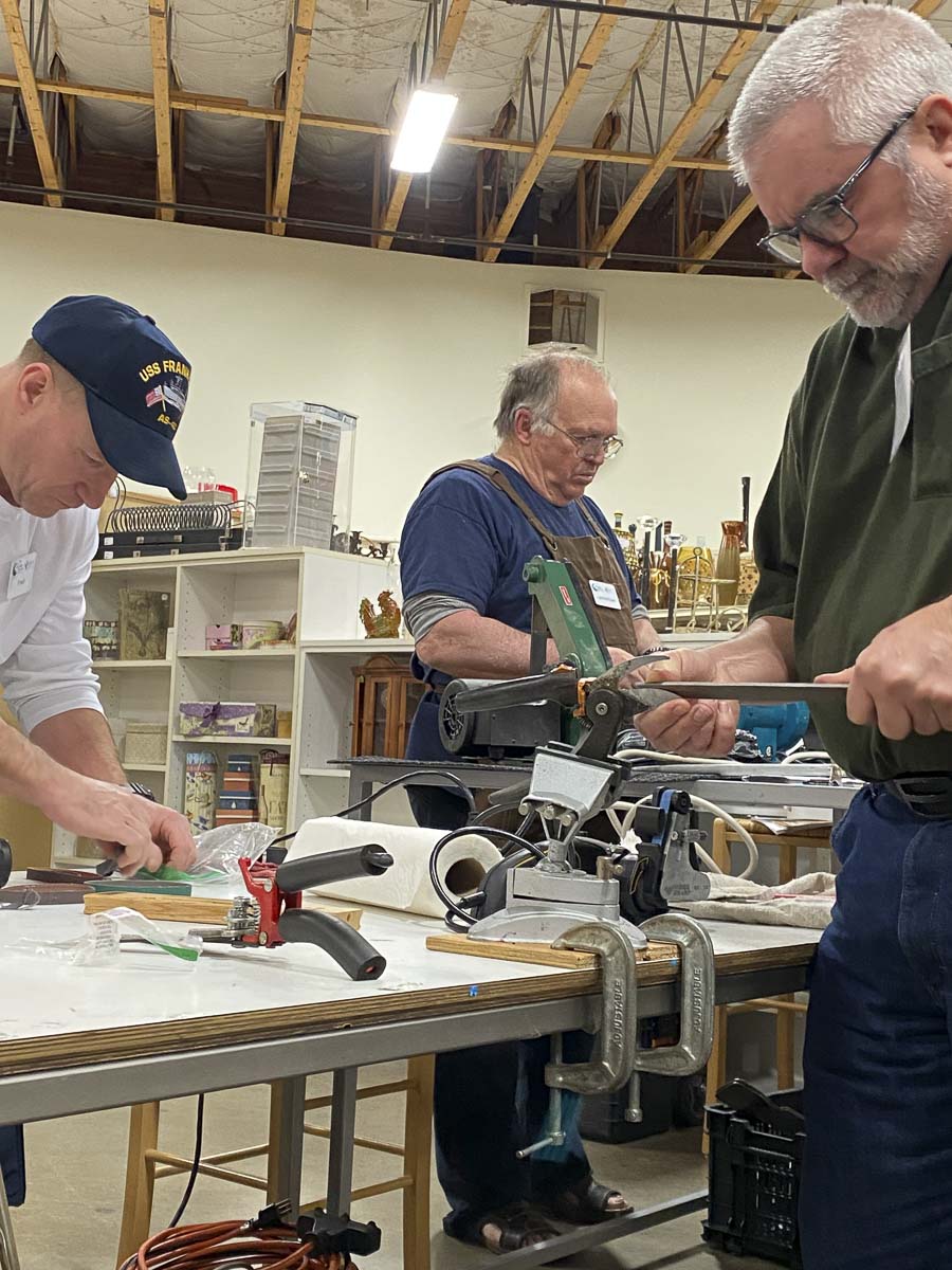 Repair Clark County volunteers Fred Davis, Les McKown and Zach Thomas sharpen dull knives and tools at the January repair event. Photo courtesy of Columbia Springs