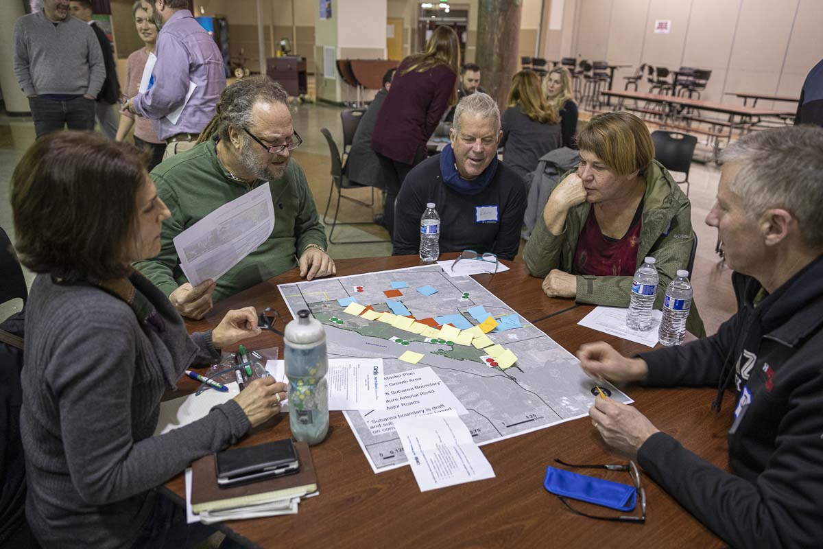 (From left to right) Camas residents Lynne Lyne, Scott Hogg, Randy Sedlak-Ford, Lyn Sedlak-Ford, and Dan Lyne work on an exercise of laying out classification for the development they’d like to see in North Shore. Photo by Jacob Granneman