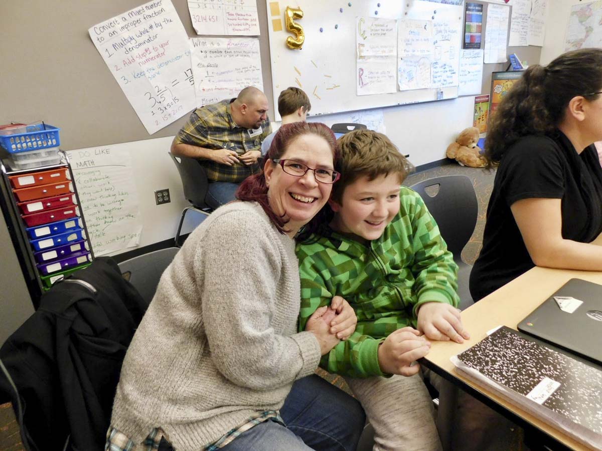 Kristi and Chase Evans join other parents and students researching rainforests at Sunset Ridge Intermediate School. Photo courtesy of Ridgefield Public Schools