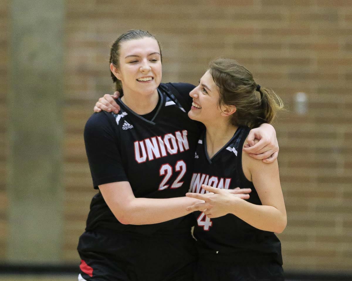 Mackenzie Lewis (22) and Mason Oberg (4) are all smiles after helping Union to a seven-seed for the upcoming Class 4A state girls basketball regional round. Photo by Mike Schultz