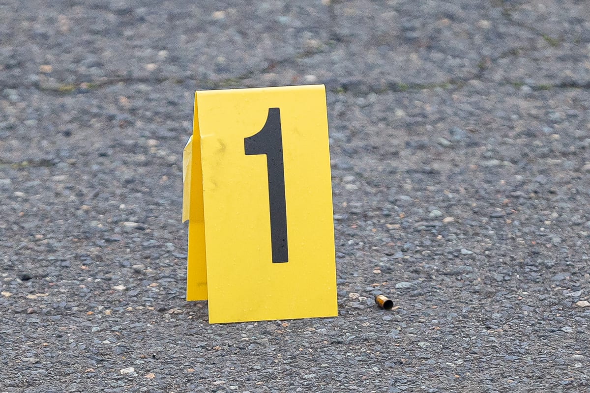 Markers show the location of shell casings in the parking lot of a business at Fourth Plain and Stapleton Road after a deadly shooting Tuesday afternoon. Photo by Mike Schultz