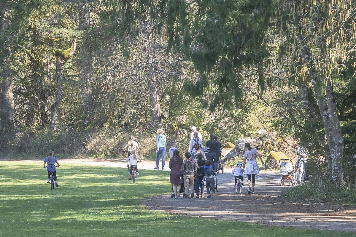 People are seen here walking the trails in Lewisville Park in Battle Ground. No parks are closed yet, due to COVID-19, but the public health department has cautioned area residents to practice social distancing. Photo by Mike Schultz