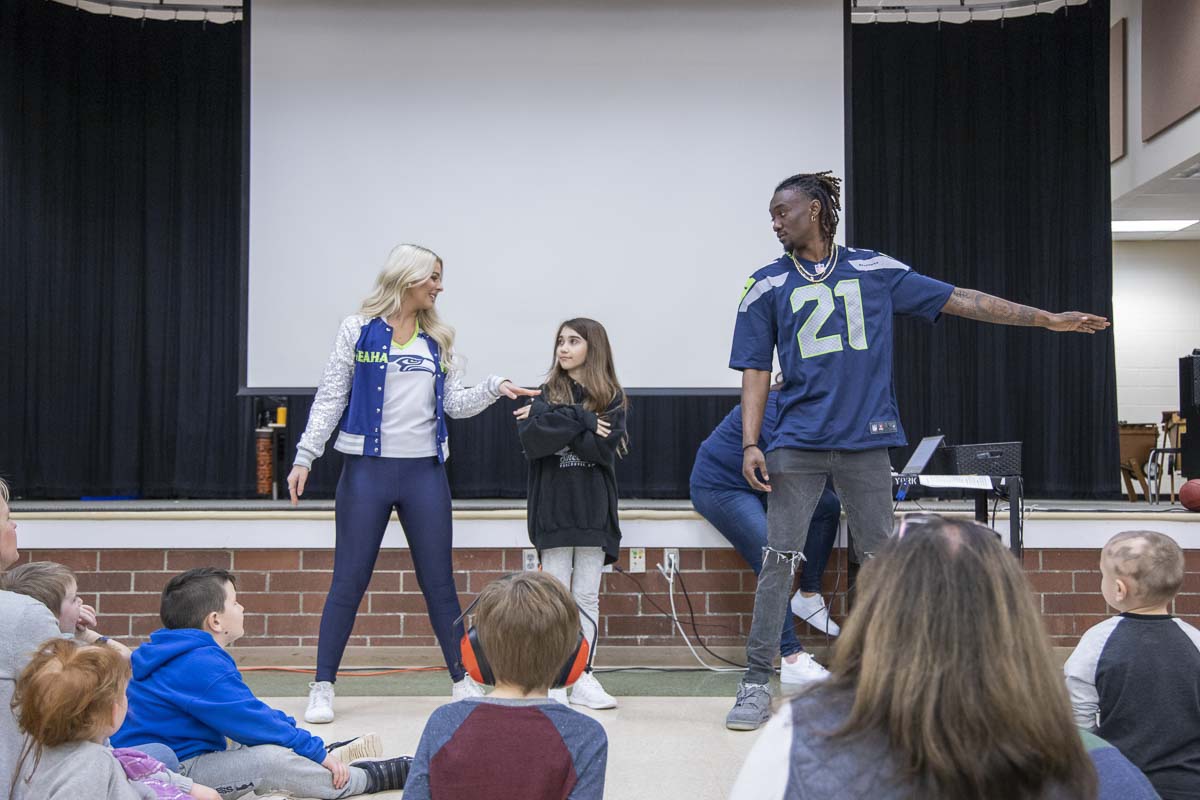 York Elementary student Lily Brasket teaches popular Tik Tok dance moves to Seahawks Dancer Kylie and Cornerback Trey Flowers at an event on Monday. Photo by Chris Brown