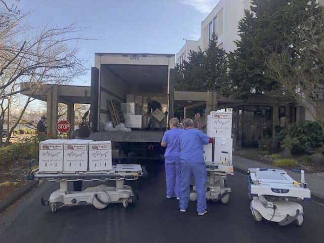 Helpers unload thousands of flowers at PeaceHealth Southwest Medical Center this week. Photo by Kristy Murray