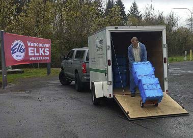A volunteer from IITRN (In It Together RN) is shown here loading his trailer with toilet paper at the Vancouver Elks Lodge. Photo courtesy of Vancouver Elks Lodge #823