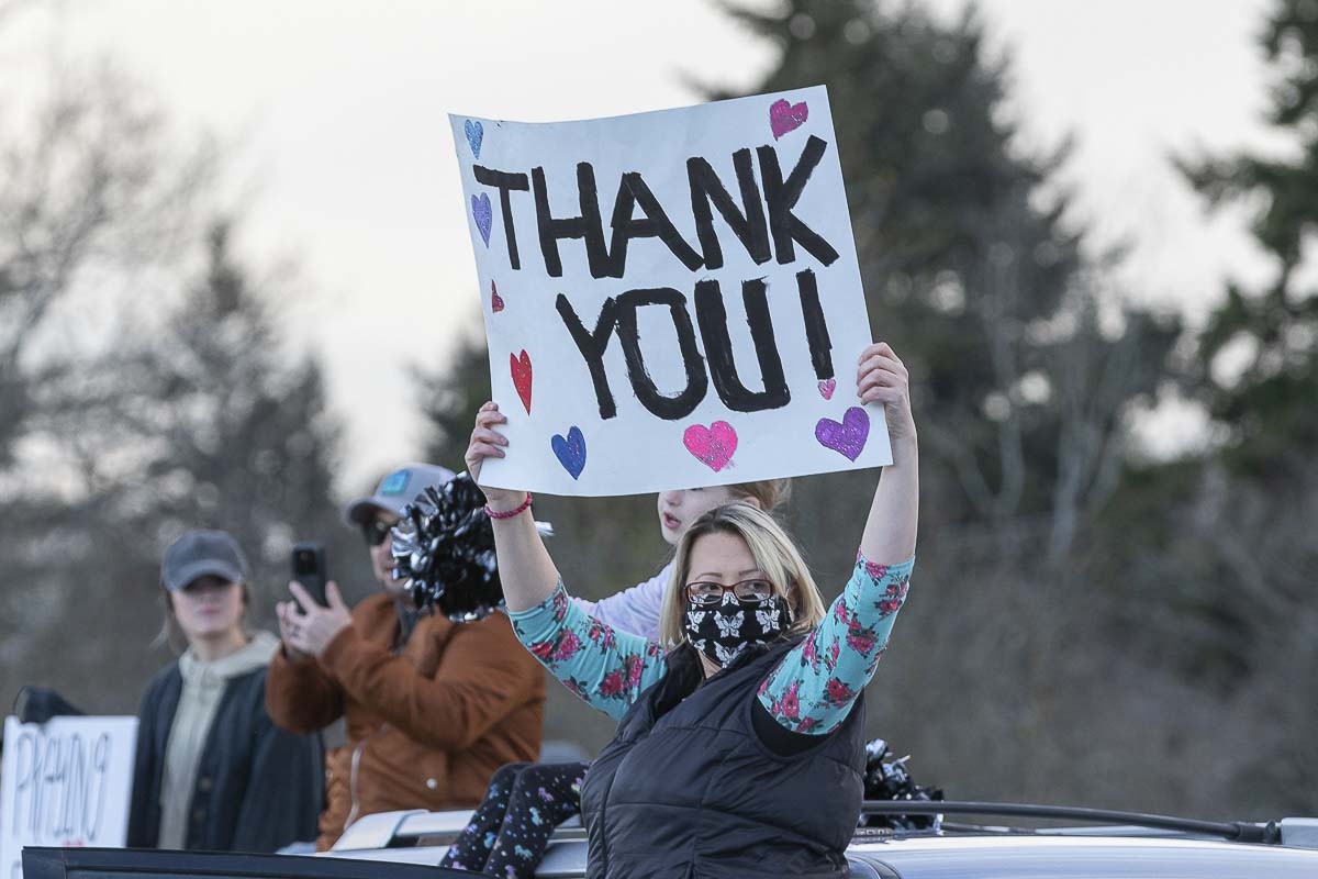 Christine Douglas of Washougal holds up a sign saying thanks to medical workers at PeaceHealth Southwest Medical Center in Vancouver on Wednesday night. Photo by Mike Schultz