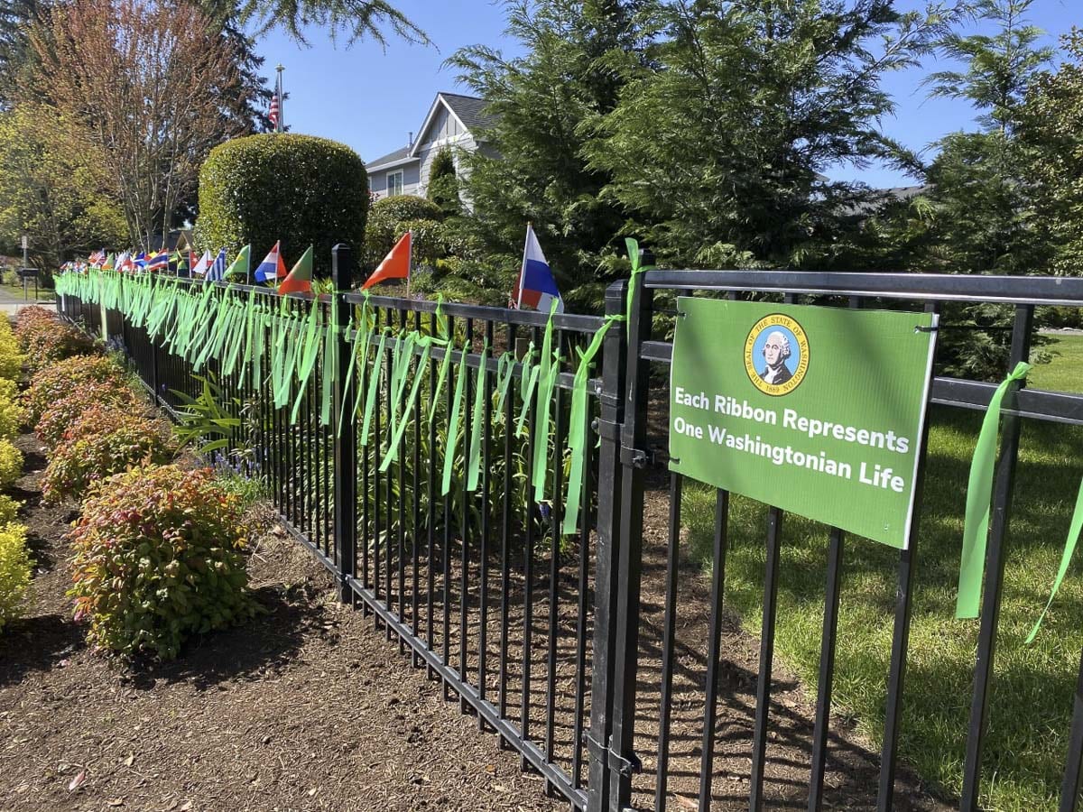 Jim Mains and his son, Remington, have been hanging green ribbons outside their Vancouver home. One for every victim of COVID-19 in Washington state. Photo courtesy Jim Mains