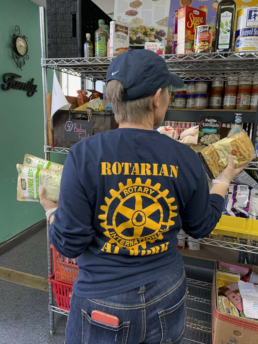 Susanne Holmberg stocks pasta shelves at North County Community Food Bank in Battle Ground. Photo courtesy of The Rotary Club of Three Creeks