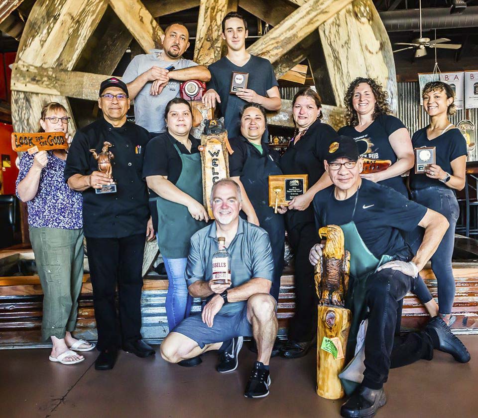 Owner Russell Brent (pictured, front center) said he and a skeleton crew at Mill Creek Pub will empty out all of the walk-ins at his restaurant and prepare food boxes for some churches in the area. The churches will be picking up the boxes and delivering them to the doorsteps of some of those in need. Photo courtesy of Mill Creek Pub